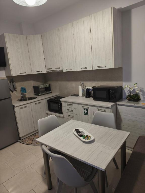 a kitchen with a table and chairs in a kitchen at Studio B1 in Mytilene