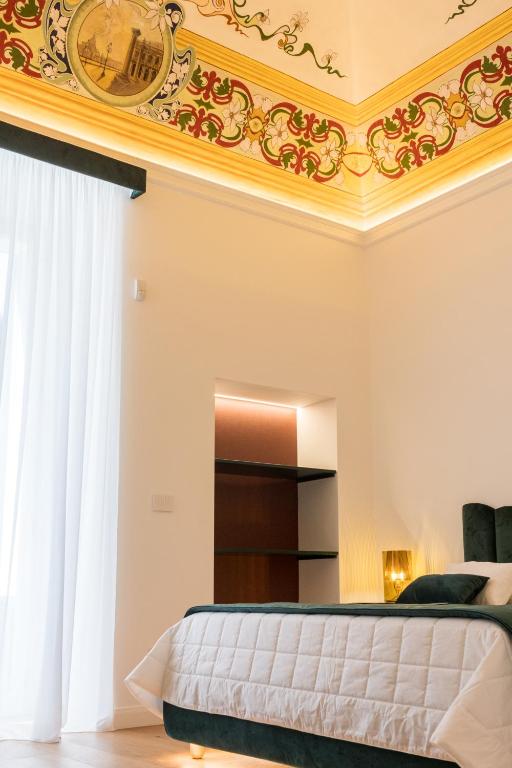 a bedroom with a gold ceiling and a bed at Casa Tanina in Bitonto