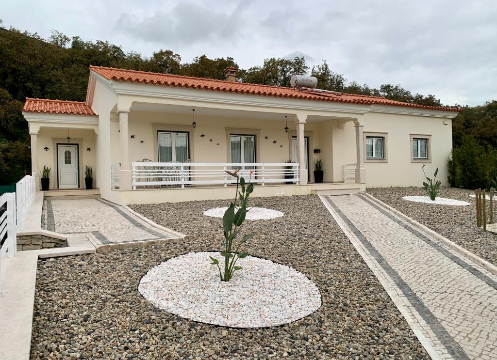 a house with a plant in the front yard at Casa Vista para a Serra in Casais do Livramento