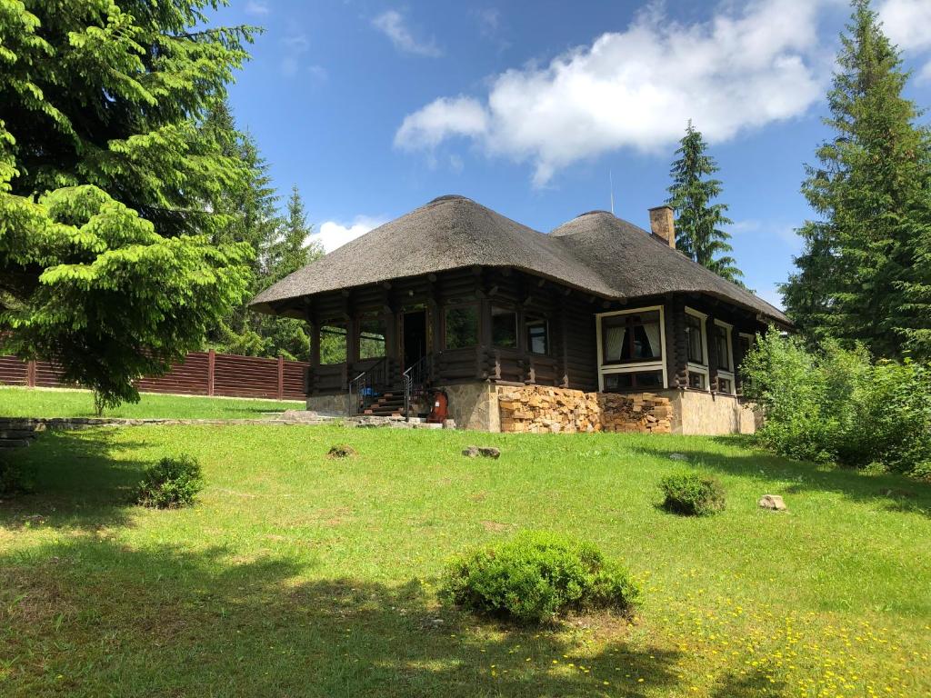 a large house with a grass roof on a field at Guta Weekend in Guta