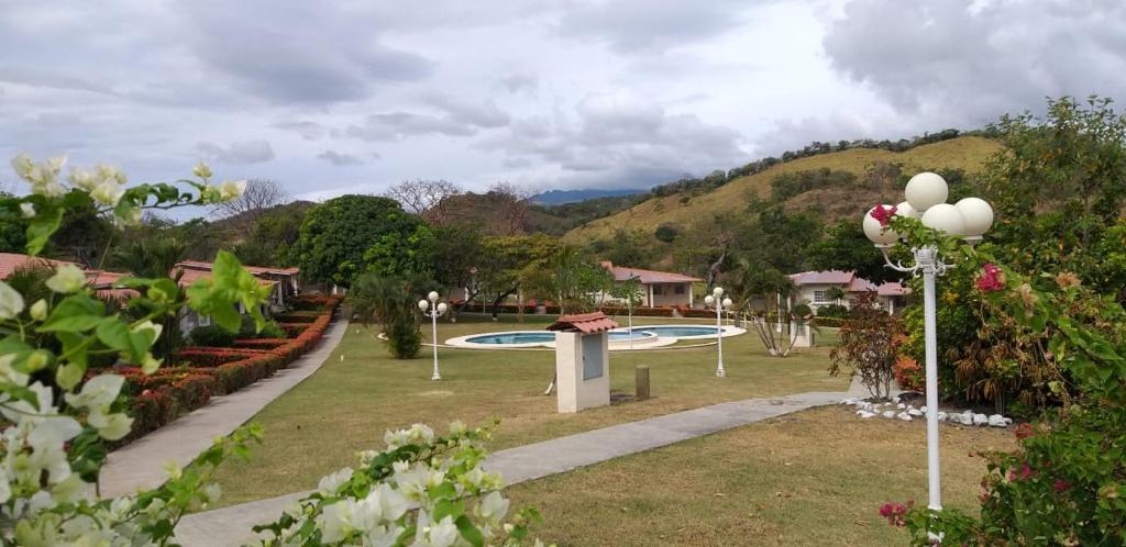 a park with a bunch of flowers and trees at Las Lajas Chalet Sweet home 2 bedrooms in Las Lajas