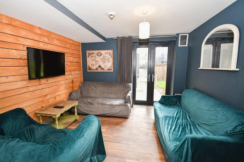 a living room with two couches and a flat screen tv at 4 Private Rooms in Shared Apartment with Kitchen in Leeds