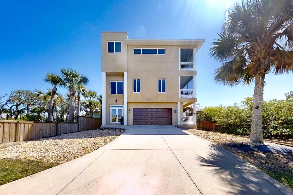 een huis met een palmboom ervoor bij NSB Indian River Waterfront Gem in Cedar Island