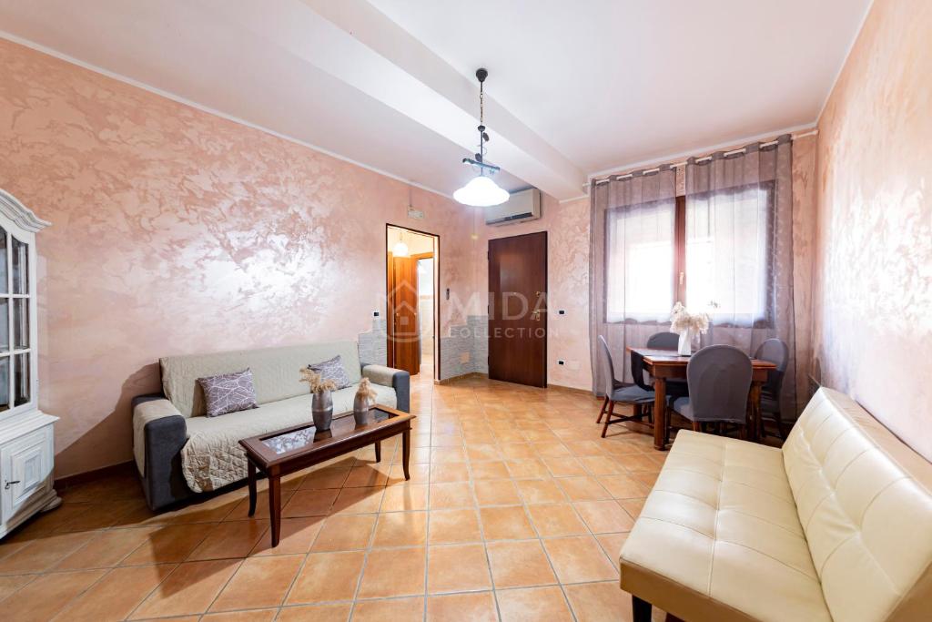 a living room with a couch and a table at Maridea Flat in Porto Cesareo