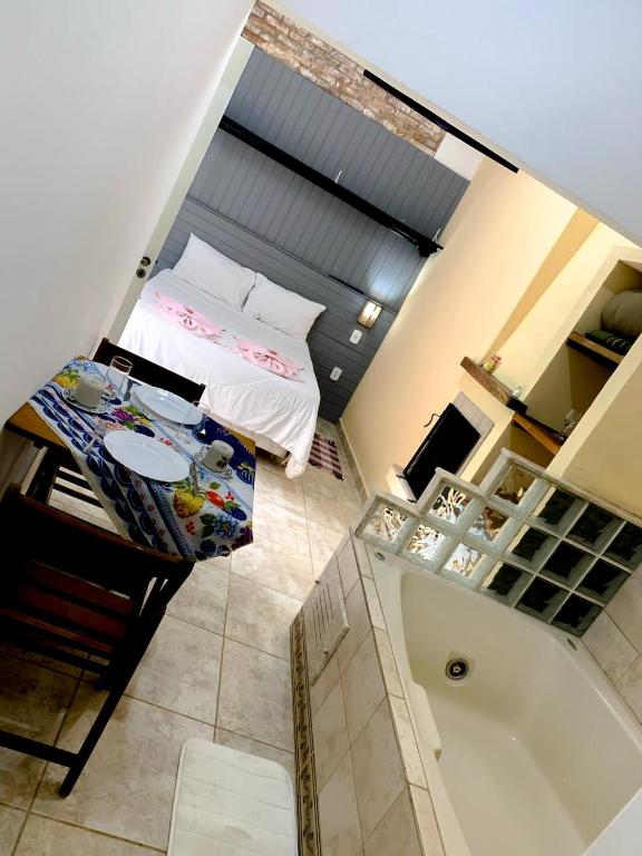 an overhead view of a bedroom with a bed and a tub at Suite Canto da Montanha in Monte Verde