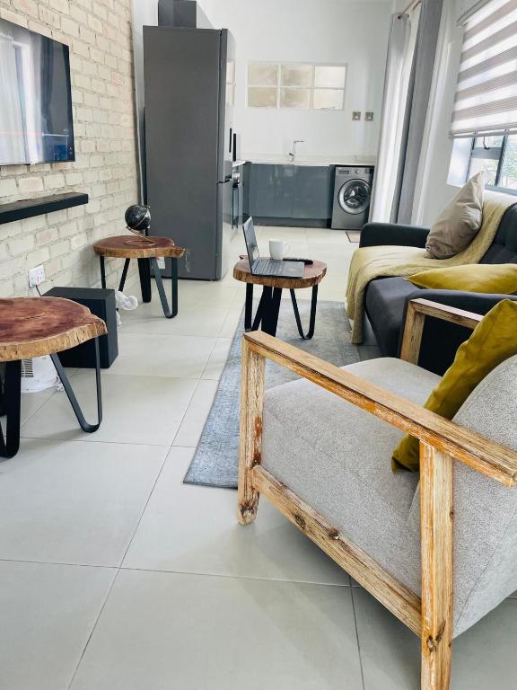 a living room with a couch and tables at Place on Oak 3 in Bulawayo