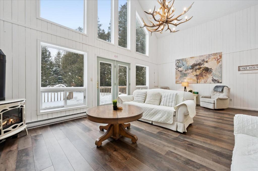 a living room with a couch and a table at Whispering Dune Winter Retreat by Singing Sands in Tobermory