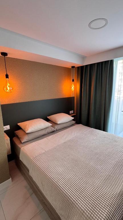 a bedroom with a large bed with two pillows at Las Americas 200A apartment in Costa de Adeje