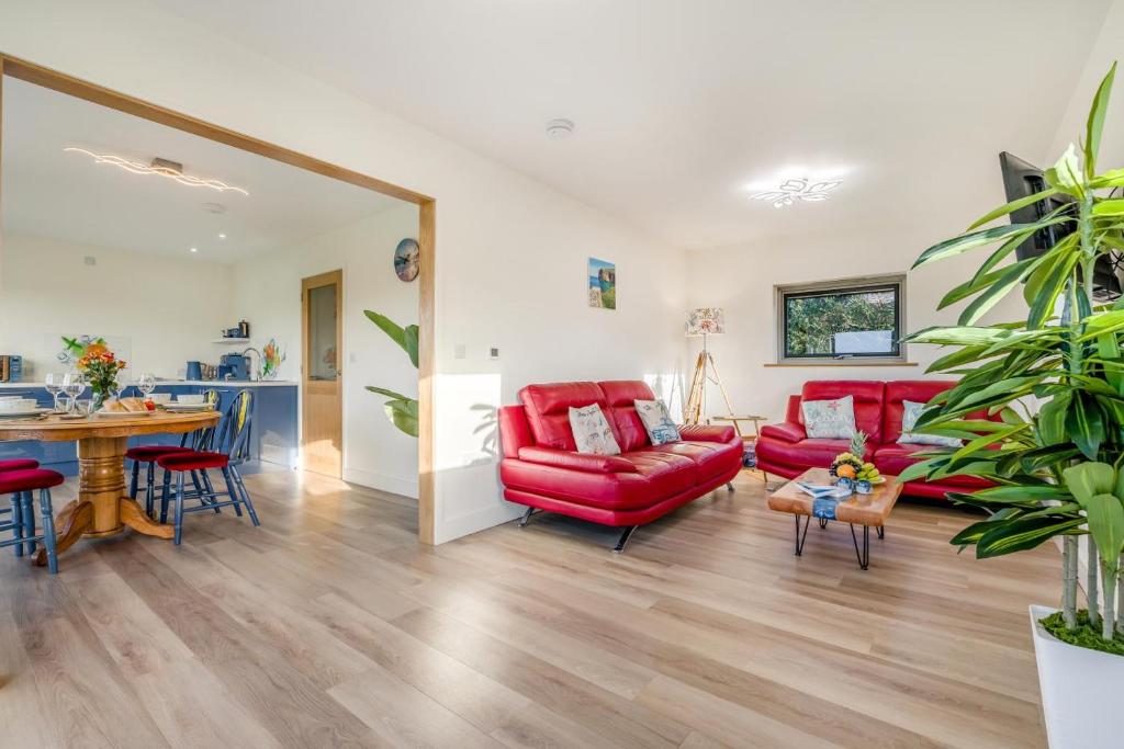 a living room with red furniture and a table at 2 Bed in Crackington Haven oc-h33817 in Crackington Haven