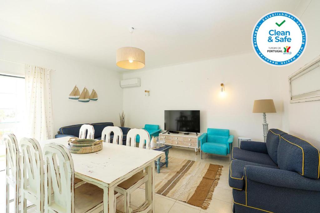 a living room with a table and chairs and a tv at C13 - Ameijeira Holiday Apartment in Lagos in Lagos