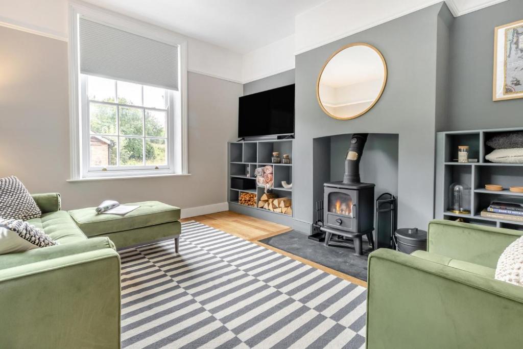 a living room with a couch and a fireplace at 3 Bed in Cyfronydd oc-e32742 in Llanfair Caereinion