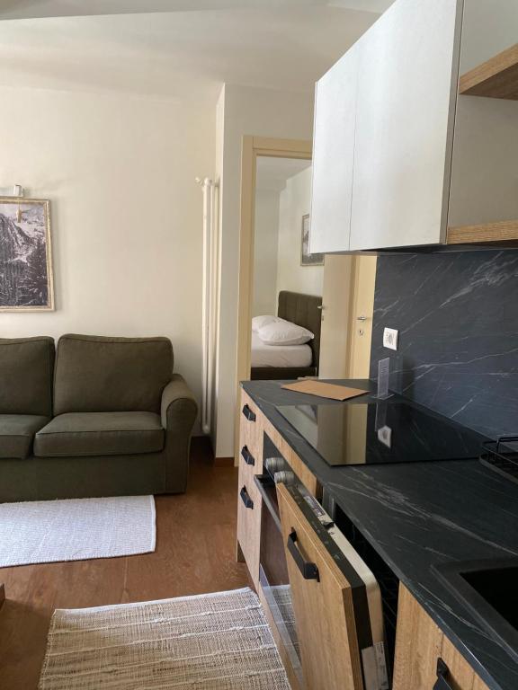 a kitchen with a couch and a living room at Maison Poluc - Chiaro di Luna in Champoluc