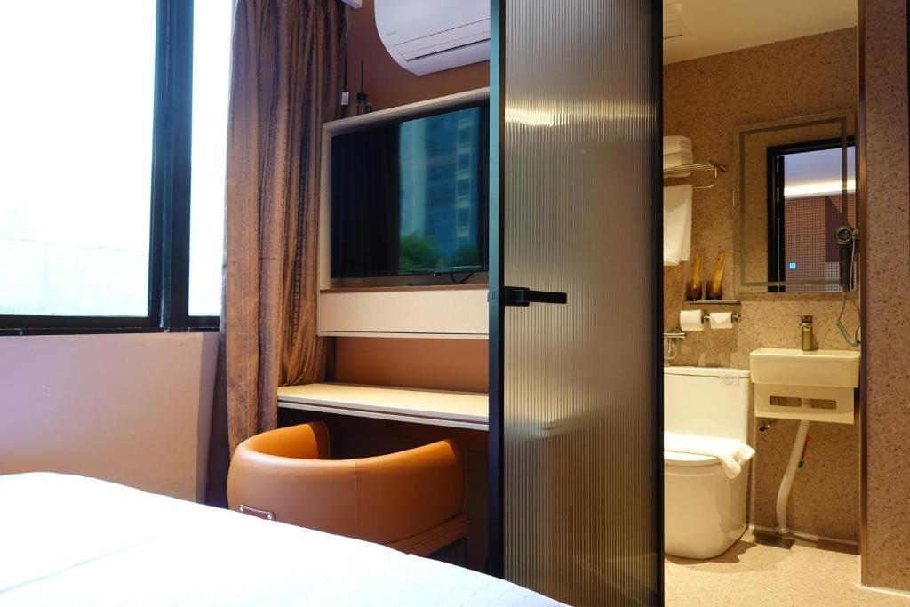 a hotel room with a bed and a bathroom at Hotel 165 - Newly Renovated in Singapore