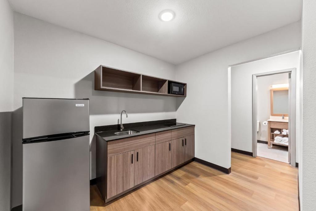 an empty kitchen with a sink and a refrigerator at Red Roof Inn Del Rio in Del Rio