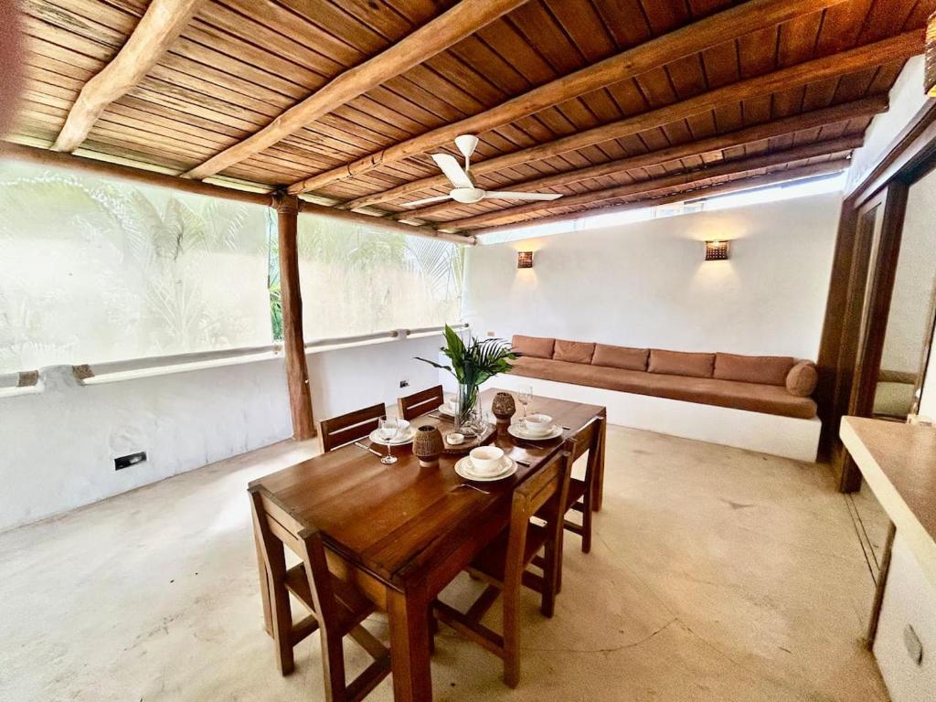 a dining room with a wooden table and chairs at Villa Las Malaguenas in Las Terrenas