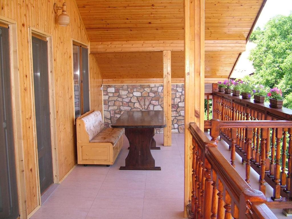 a porch with a bench on a wooden deck at Kisiovi Apartment in Devin