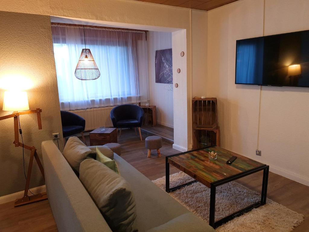a living room with a couch and a coffee table at Ferienwohnung am Hotel "Mein Bergblick" in Goslar