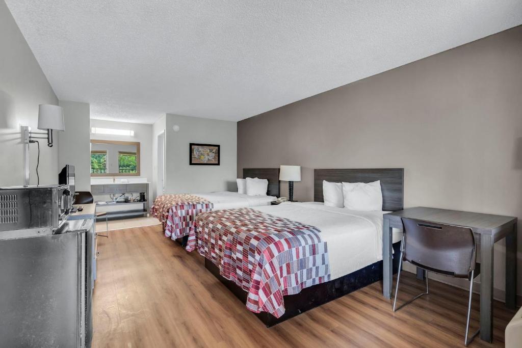 a hotel room with two beds and a kitchen at Red Roof Inn MacClenny in Macclenny