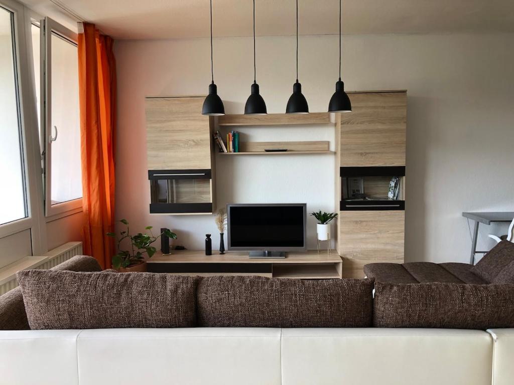 ein Wohnzimmer mit Sofa und Fernseher in der Unterkunft Apartment in Herborn mit Balkon & Weitblick ins Grüne in Herborn