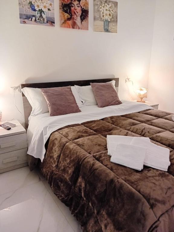 a bedroom with a large bed with two pillows on it at Il Don Giovanni Room in Barletta