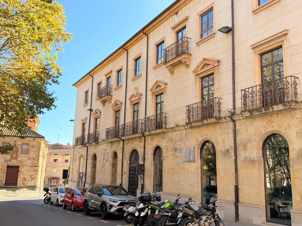 a large building with motorcycles parked in front of it at Domus Altiora Centro in Salamanca