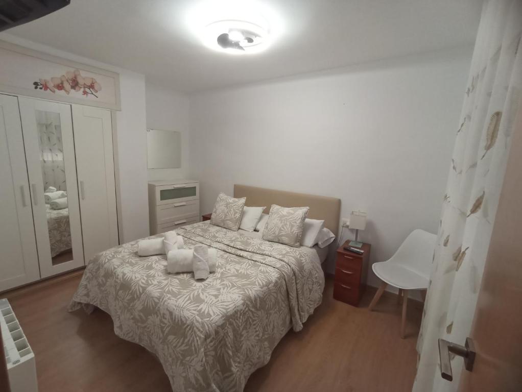 a bedroom with a bed with two towels on it at Brisas del Mar in Salou