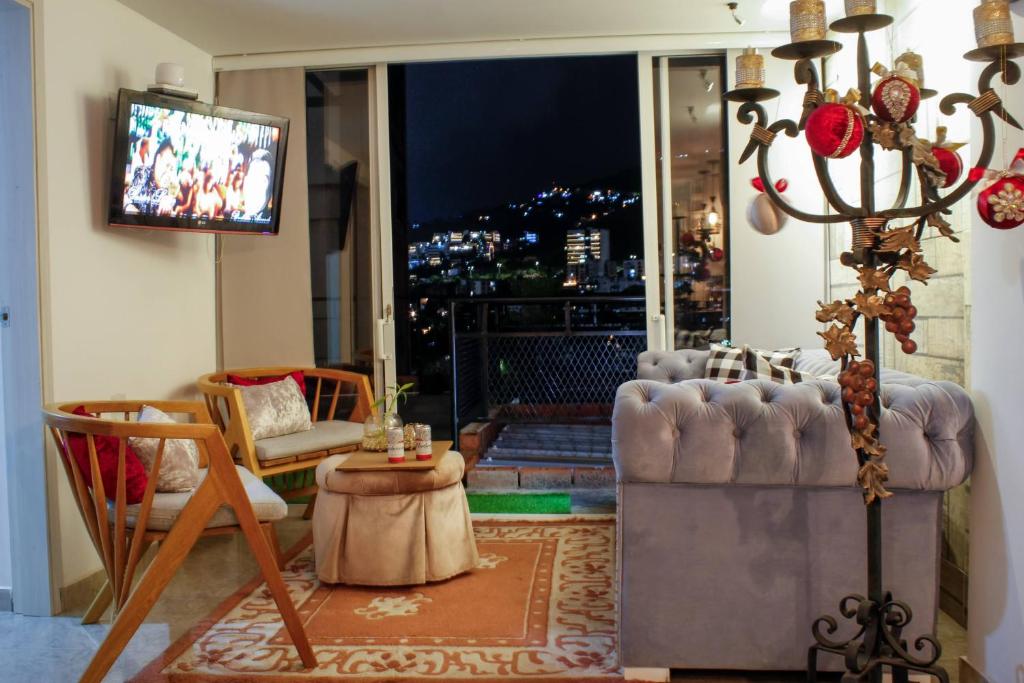 a living room with a couch and a television at My Bunker in Cali