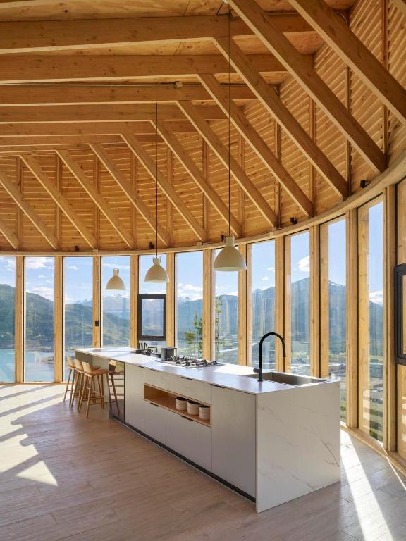 a kitchen with a large island in a room with windows at Casa p in Bahía Murta