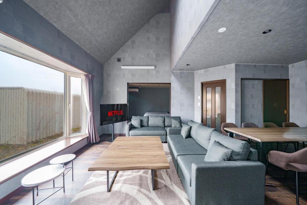 a living room with a couch and a table at Prostimo in Bibai