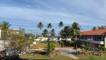 a resort with palm trees and a building at Praia de Guaibim in Valença