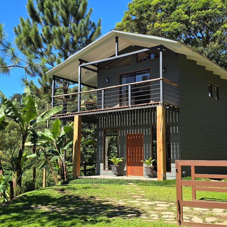 a black house with a balcony and a porch at Monteverde Casa Mia, near main attractions and town! in Monteverde Costa Rica