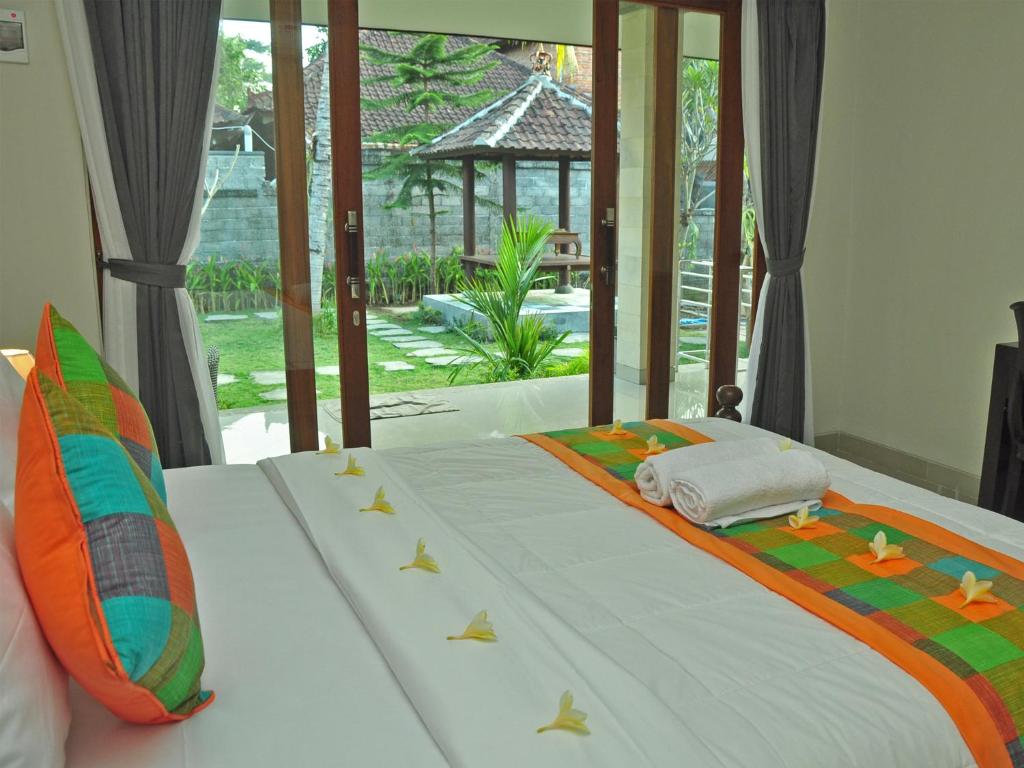 Postel nebo postele na pokoji v ubytování Putu's Paradise Guesthouse