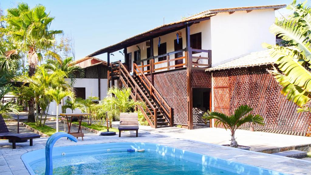 un resort con piscina di fronte a un edificio di Casa Camboa - Barrinha - Praia do Preá ad Acaraú