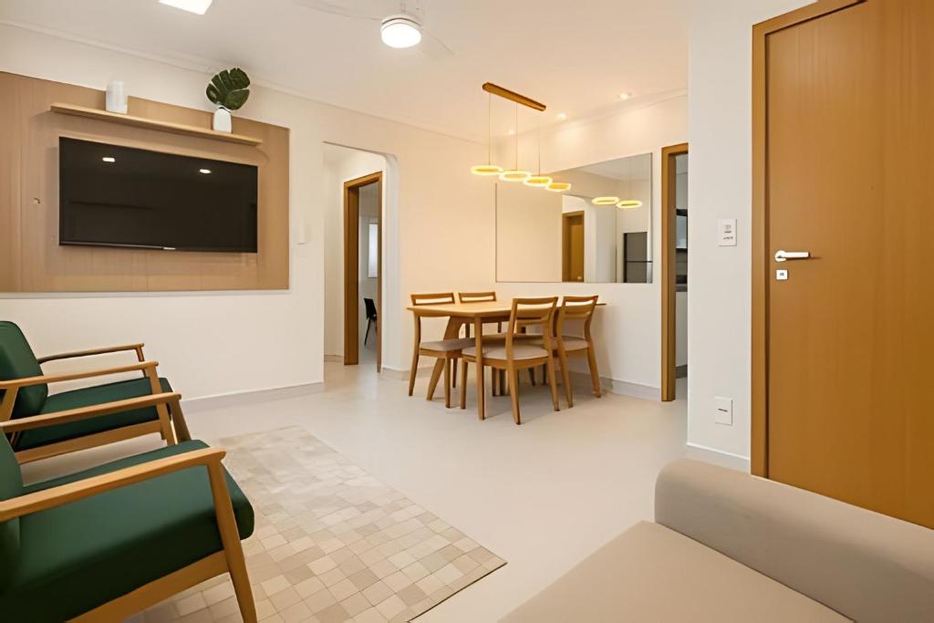 un soggiorno e una sala da pranzo con tavolo e sedie di Itaparica Beira-Mar [Confortável e Pé na areia] a Vila Velha