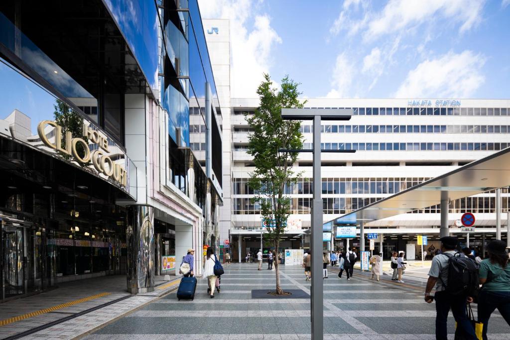 a group of people walking through a shopping mall at Hotel Clio Court Hakata in Fukuoka