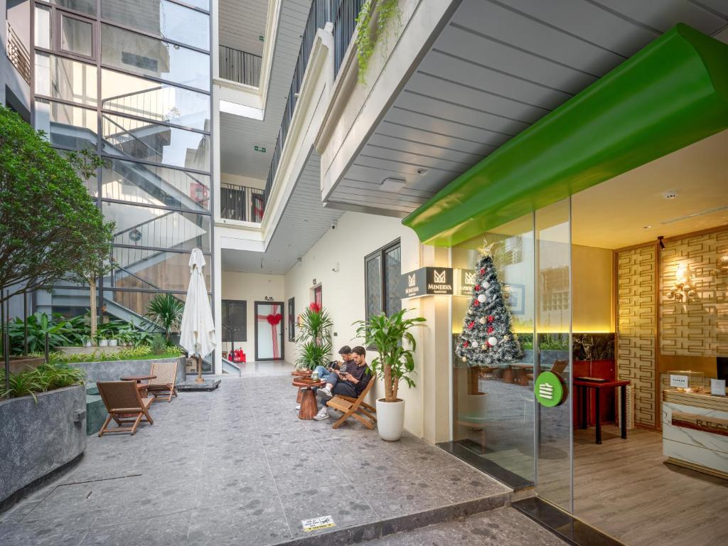 a group of people sitting in the lobby of a building at Minerva Aparthotel Hanoi in Hanoi