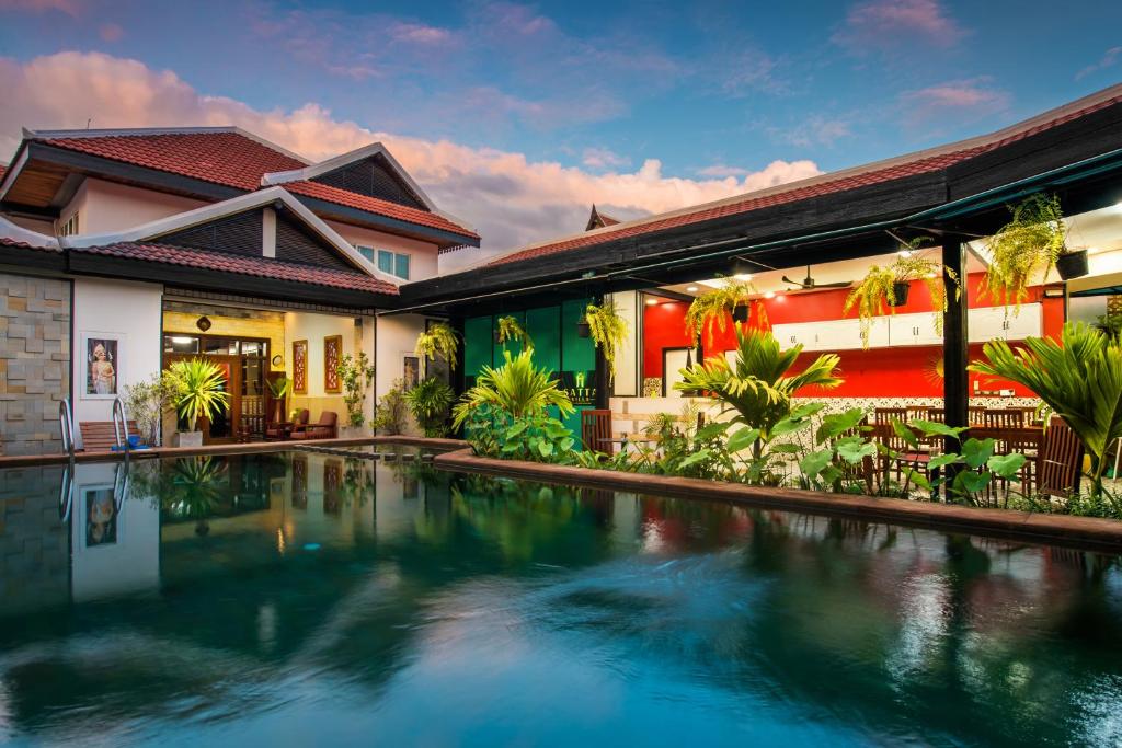 a house with a swimming pool in front of it at SATTA Private Pool Grill & Chill Villa in Siem Reap