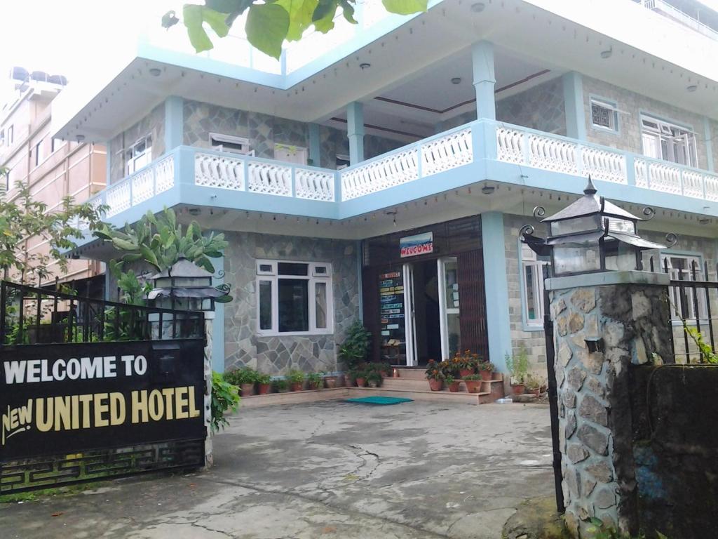 a building with a welcome sign in front of it at New United Hotel in Pokhara