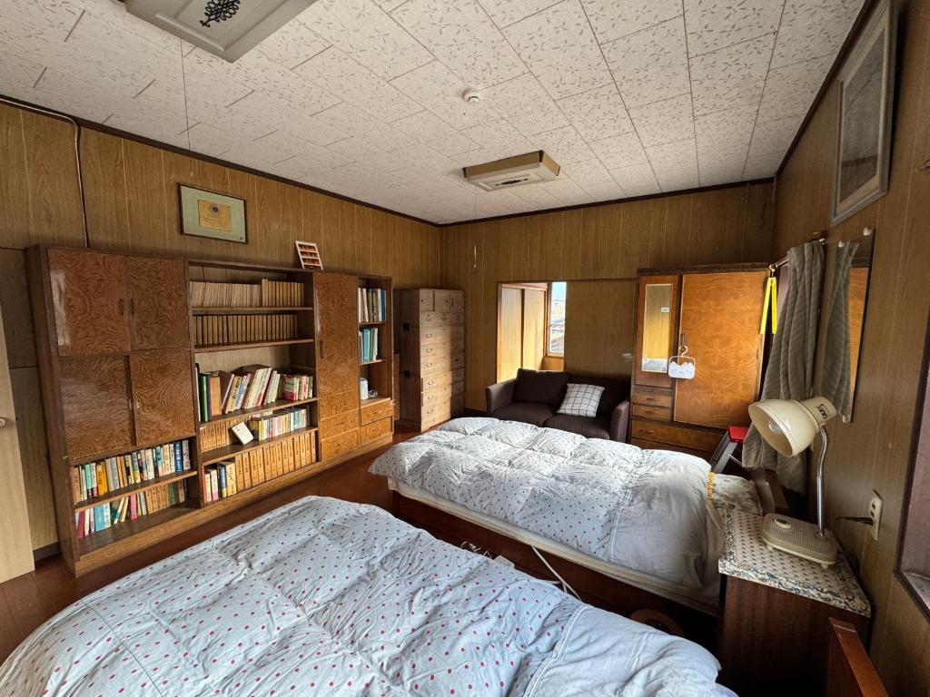 Postel nebo postele na pokoji v ubytování 昭和レトロの民泊 正直屋