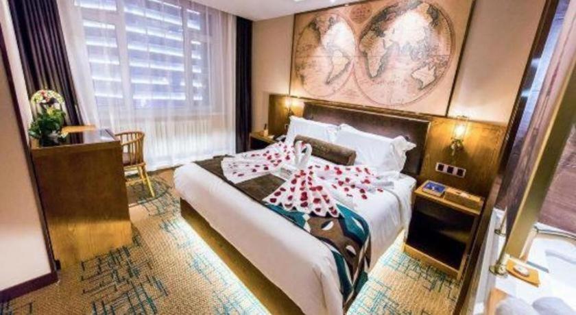 a hotel room with a bed and a large window at James Joyce Coffetel Changchun People's Square in Changchun