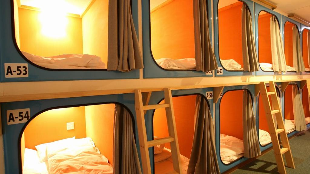 a row of bunk beds in a hostel at カプセルホテルグロリア in Beppu
