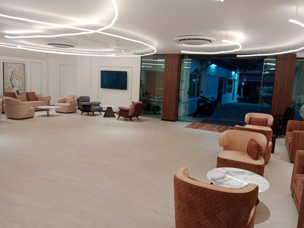 een lobby met banken en stoelen in een gebouw bij Hotel Soni Mansion Pratunam in Bangkok