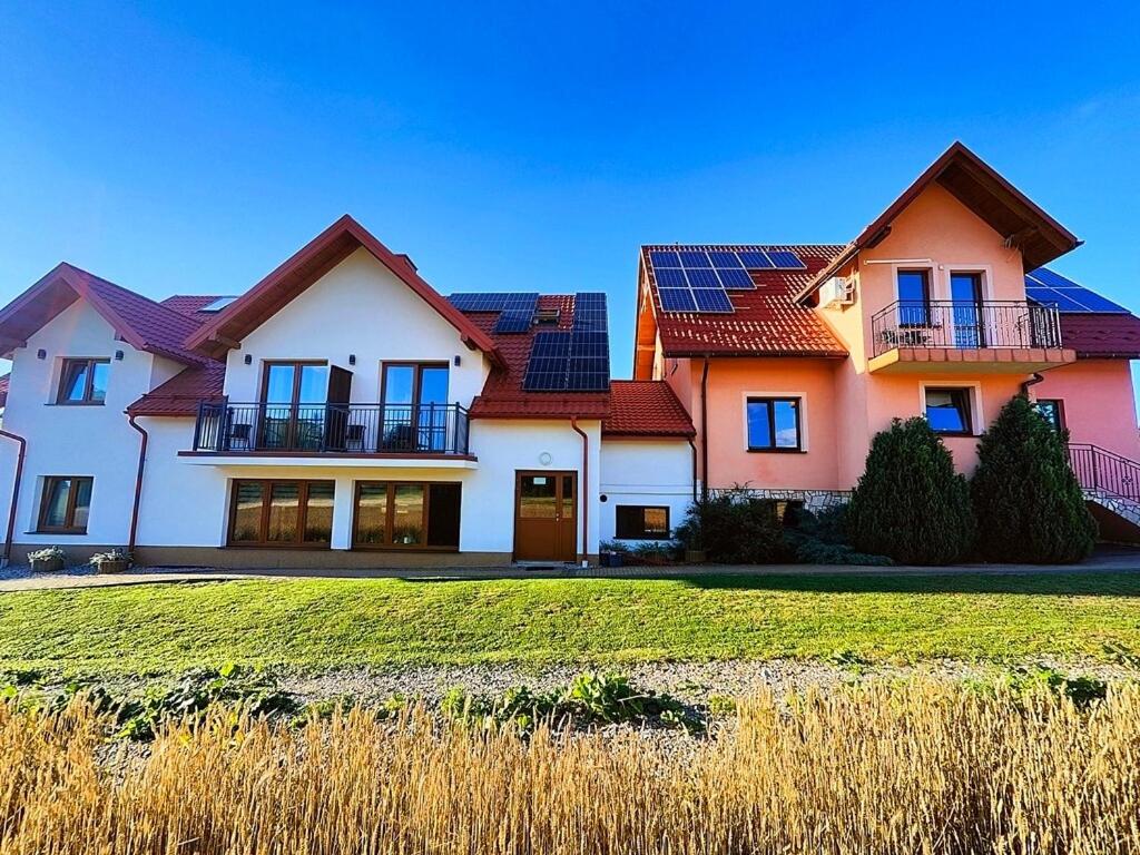 a house with solar panels on top of it at Dom Wypoczynkowy Marta in Kacwin