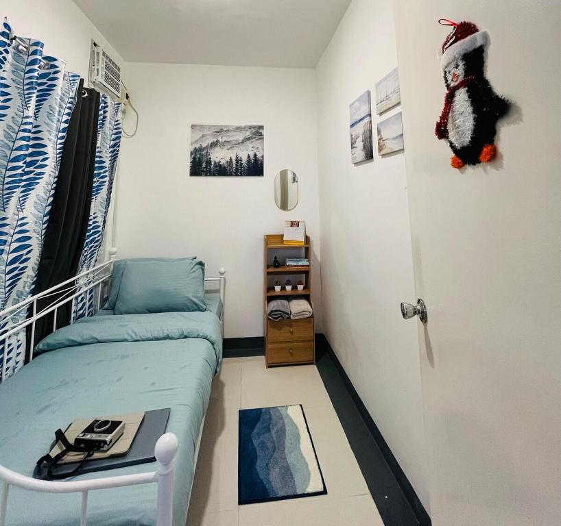 a small room with a bed and a door at Selah Stay in Manolo Fortich