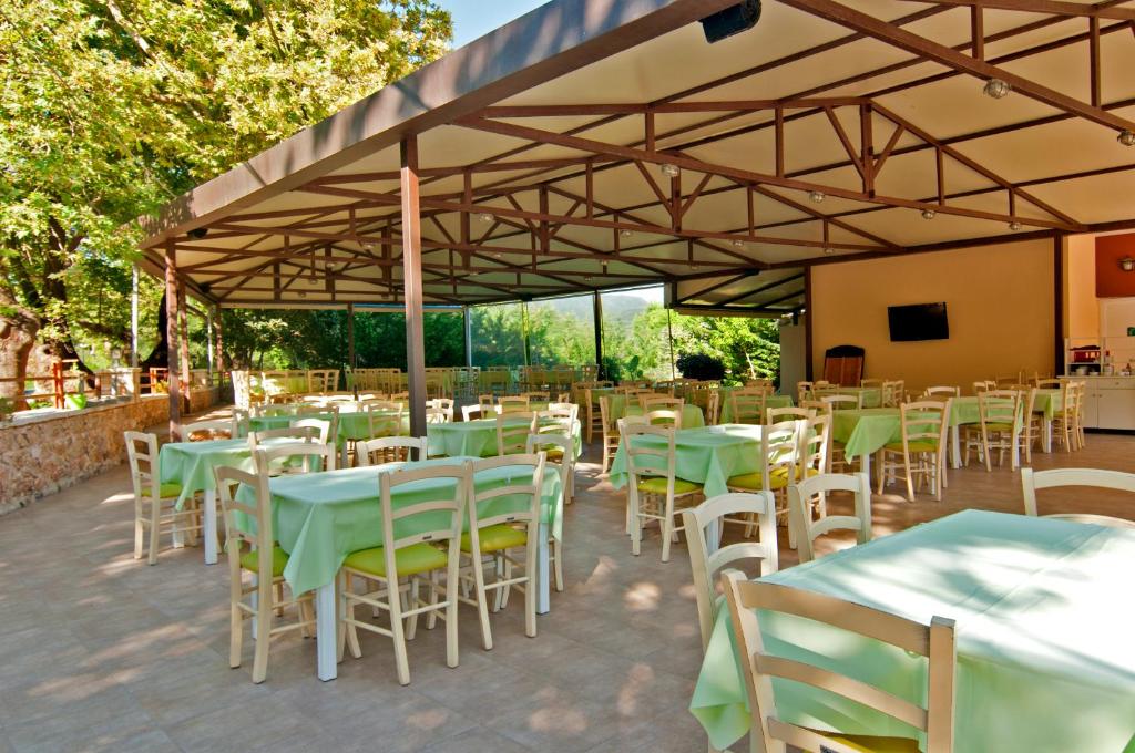 a group of tables and chairs under a large tent at Riviera Perdika Hotel in Perdika