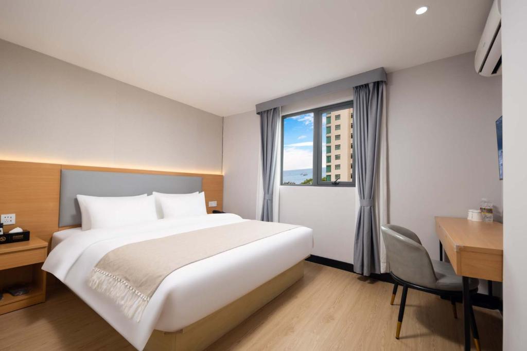 Ένα ή περισσότερα κρεβάτια σε δωμάτιο στο 三亚观海楼酒店（三亚湾椰梦长廊店）