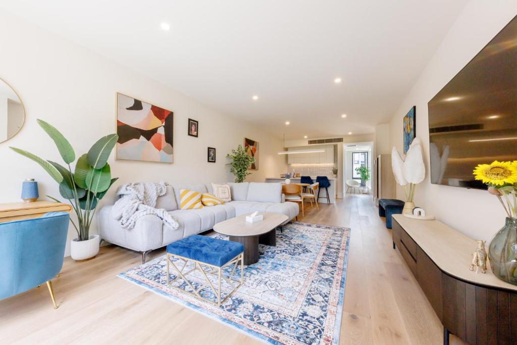 a living room with a couch and a table at Port Melbourne Marvel in Melbourne