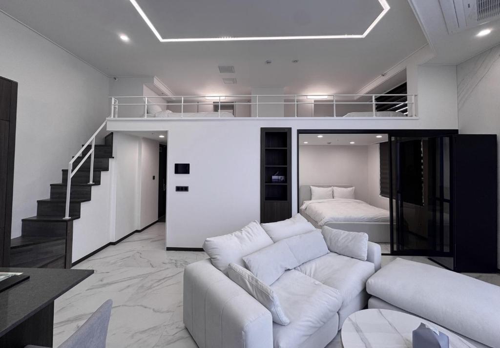 a living room with a white couch and a loft at Namsan Dream City in Seoul