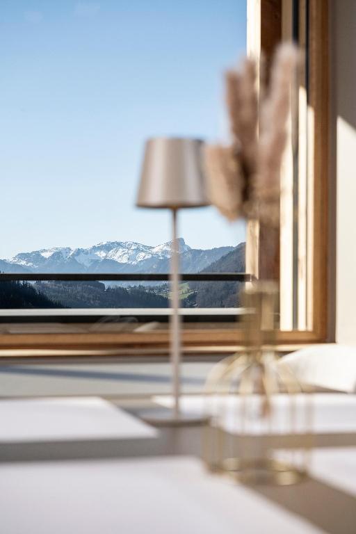 a small lamp sitting on a table in front of a window at Chalet Valora in Le Grand-Bornand