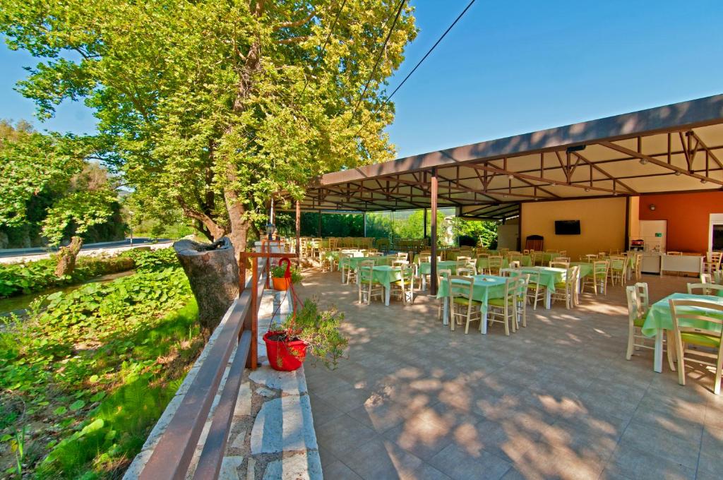 a group of tables and chairs under a pavilion at Riviera Perdika Hotel in Perdika